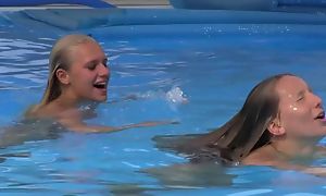 Two pulchritudinous girls swimming and seal the doom wits the pool